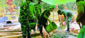 Anggota Satgas Yonif 144/JY Karya Bhakti Pemasangan Keramik Makam Warga di Perbatasan