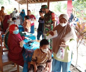 Dengan Penuh Kehangatan Babinsa Dampingi Anak Anak Terima Vaksin